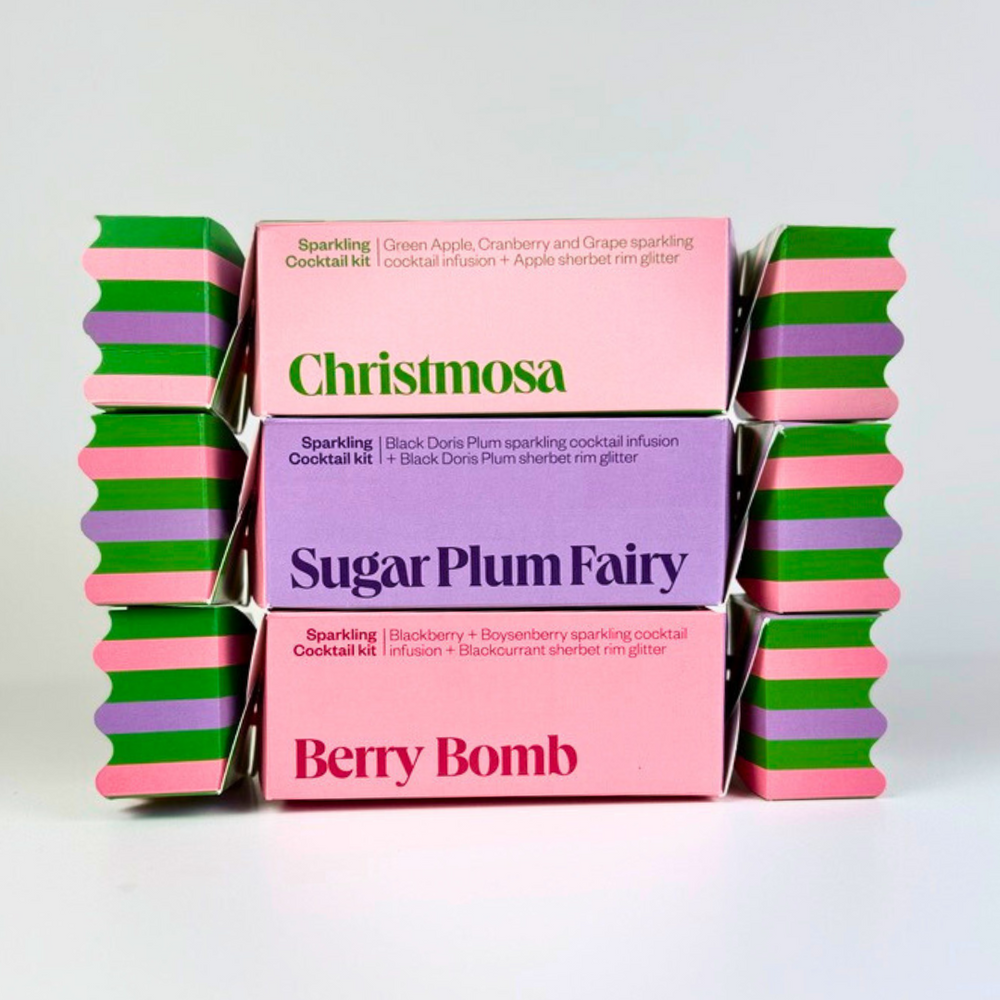 
                  
                    Three colorful cocktail kit boxes with 'Christmosa', 'Sugar Plum Fairy', and 'Berry Bomb' text on a white background.
                  
                